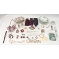 A collection of costume jewellery including an angel coral bead necklace, several silver brooches an... 