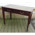 An Edwardian two drawer desk, tooled leather top, square section tapering legs.