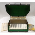 A Hohner accordion, in original carry case, together with a Smith Corona portable typewriter, in ori... 