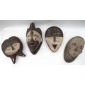 A group of four carved and painted 20th century reproduction tribal African masks, mostly from West ... 