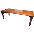 An early 20th century mahogany bed table with folding hinged legs.