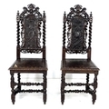 A pair of Jacobean style side chairs, early 20th century, with carved crest backs, barley twist supp... 