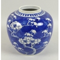 A Chinese porcelain ginger jar, decorated in underglaze blue with prunus blossom against a cracked i... 