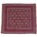 A Gazak rug with diamond pattered field, dark red and blue, divided by white stripes, 130 by 115cm.