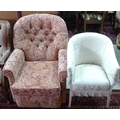 A pink floral upholstered armchair and a cream and wicker upholstered armchair. (2)