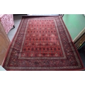 A modern red ground rug, 170 by 240cm.