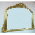 A gilt framed over mantle mirror.