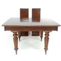 An early 19th century mahogany extending dining table, with two additional leaves, raised on turned ... 