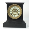 A slate mantel clock with visible escapement, Ansonia movement, and black Roman numerals, 25cm high.