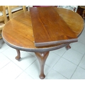 A 20th century mahogany dining table, with extra leaf, together with a set of four dining chairs.