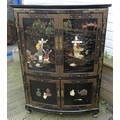 A modern decorative Japanned corner cupboard, decorated with figures against a mountainous landscape... 