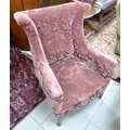 A small mid 20th century wing armchair, with outswept wings, square section supports upholstered in ... 