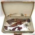 A selection of items contained within a mid 20th century military suitcase, including an unusual met... 