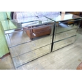A pair of modern mirrored glass three drawer chests, together with a pair of matching small bedside ... 