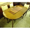 A walnut veneered dining suite, circa 1964, comprising an extending dining table with single leaf, a... 