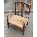 A 19th century wheel back low chair with rush seat