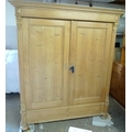 A French 19th century stripped pine armoire, two full length doors enclosing a hanging space.