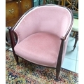 An Arts & Crafts style tub armchair, circa 1960, with bowed back, upholstered in salmon pink velour.