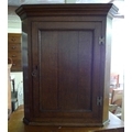 A George III oak flat fronted corner cupboard, with brass H hinges, single door enclosing two fixed ... 