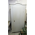 A French style single wardrobe painted distressed grey, with carved pediment and raised on short leg... 