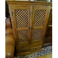 A modern South East Asian hardwood TV cabinet, twin lattice doors over four drawers, with black pain... 