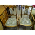 A pair of mid 20th century stained beech open armchairs, with embroidered fabric padded seats and ba... 