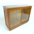 An early 20th century Australian pine shop display cabinet, with two sliding glass doors, two full w... 