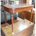 A 19th century mahogany card table, of D form with fold over top, crossbanded, raised on turned legs... 