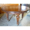 A 19th century mahogany draw leaf table, circular surface with single leaf, spiral reeded tapered le... 