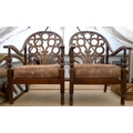 A pair of vintage low armchairs, with rounded backs, pierced flower design splats and padded seats. ... 