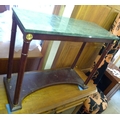 A modern side table, with green veined marble top, column supports and shaped floor level platform b... 