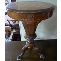 A late Victorian games / work table with faceted body, lift lid revealing a fitted interior with com... 
