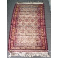 A small Persian rug, with red ground, four and two half rows of repeating geometric medallions, mult... 