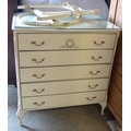 A group of furniture, comprising a French style cream painted dressing chest with oval mirror and fi... 