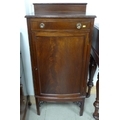 A mid 20th century mahogany music cabinet, drawer with ring handles over a cupboard with four shelve... 