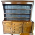 An early 19th century mahogany Welsh dresser, wide cornice over a three shelf plate rack with the ba... 