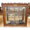 A set of laboratory scales in five glass case, labelled River Chemical Co Ltd, Laboratory Furnishers... 