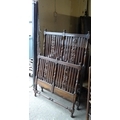 A mid 20th century stained oak double bed frame, the ends with slatted, turned column, and carved de... 