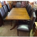 A set of eight black faux leather upholstered dining chairs, a/f well worn.