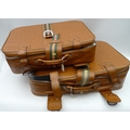 A pair of vintage brown suitcases.