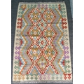 A vegetable dyed wool Chobi Kelim rug, with diamond patterned field and geometric borders in green, ... 