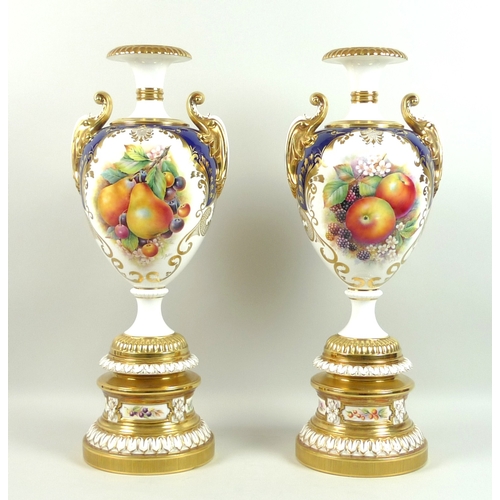 60 - A pair of large modern Royal Worcester pedestal vases, foliate clasped twin handles, decorated in a ... 