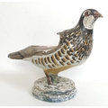 An 18th century Spanish faience sauce boat by Alcora, modelled in the form of a quail, the body poly... 