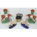 A pair of 19th century Staffordshire greyhound pen stands or ink wells, 11cm high, together with a p... 