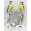 A pair of Sitzendorf figurines, modelled as parrots, each standing on a naturalistic branch with app... 
