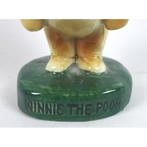 4 - A rare group of six Fulham Pottery Winnie-the-Pooh figurines, mid 20th century, modelled as Winnie T... 