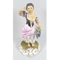 A Royal Crown Derby porcelain figurine, modelled as 'Autumn', a lady standing holding bunches of gra... 