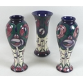 A Moorcroft Pottery garniture of three vases, decorated in the 'A tribute to Charles Rennie Mackinto... 