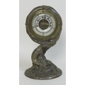 A late 19th or early 20th century barometer, unusually formed as a mermaid holding a lifebuoy aloft,... 