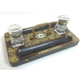 A Victorian ebonised and brass mounted inkwell.